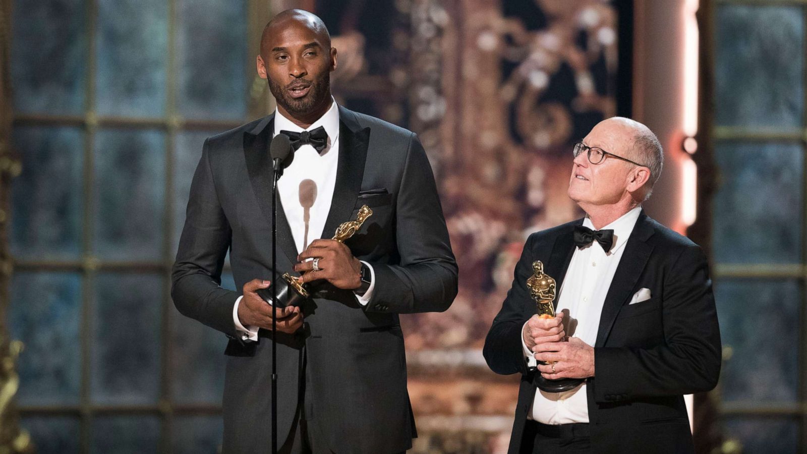 PHOTO: Kobe Bryant, left, speaks after accepting his award during the 90th Academy Awards in Hollywood, Calif., March 4, 2018.