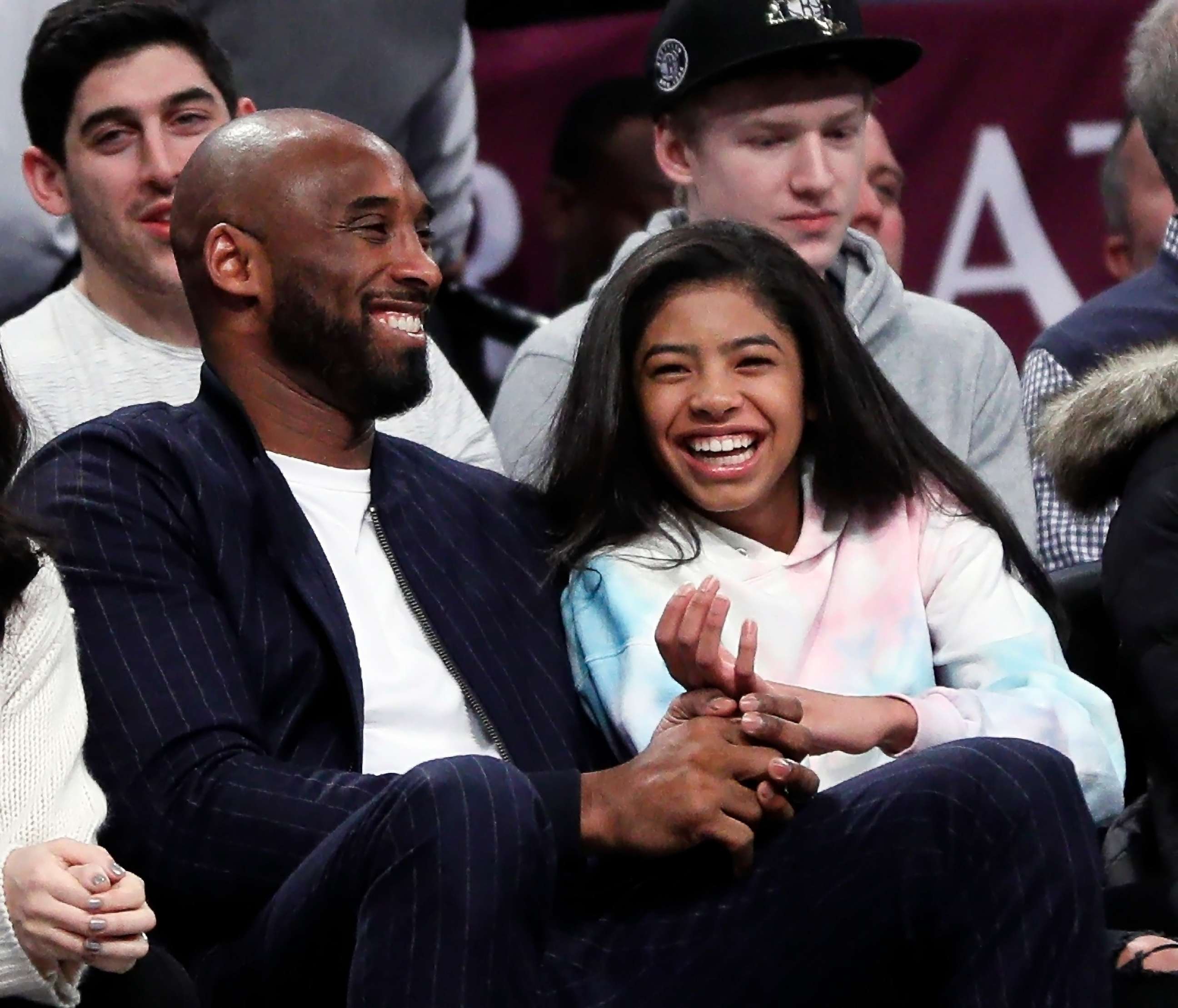 PHOTO: In this file photo, Kobe Bryant and his daughter Gigi watch an NBA basketball game between the Brooklyn Nets and Atlanta Hawks at Barclays Center in the Brooklyn borough of New York City, Dec. 21, 2019.