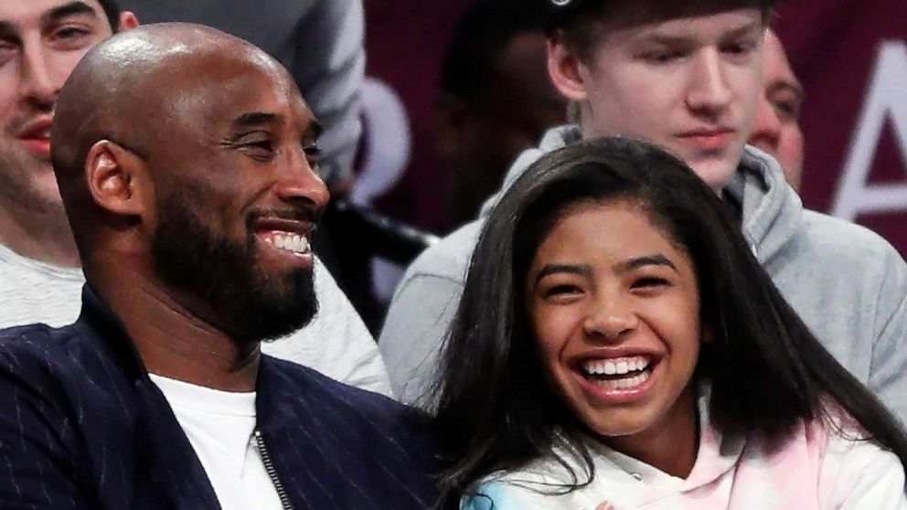 PHOTO: In this file photo, Kobe Bryant and his daughter Gigi watch an NBA basketball game between the Brooklyn Nets and Atlanta Hawks at Barclays Center in the Brooklyn borough of New York City, Dec. 21, 2019.