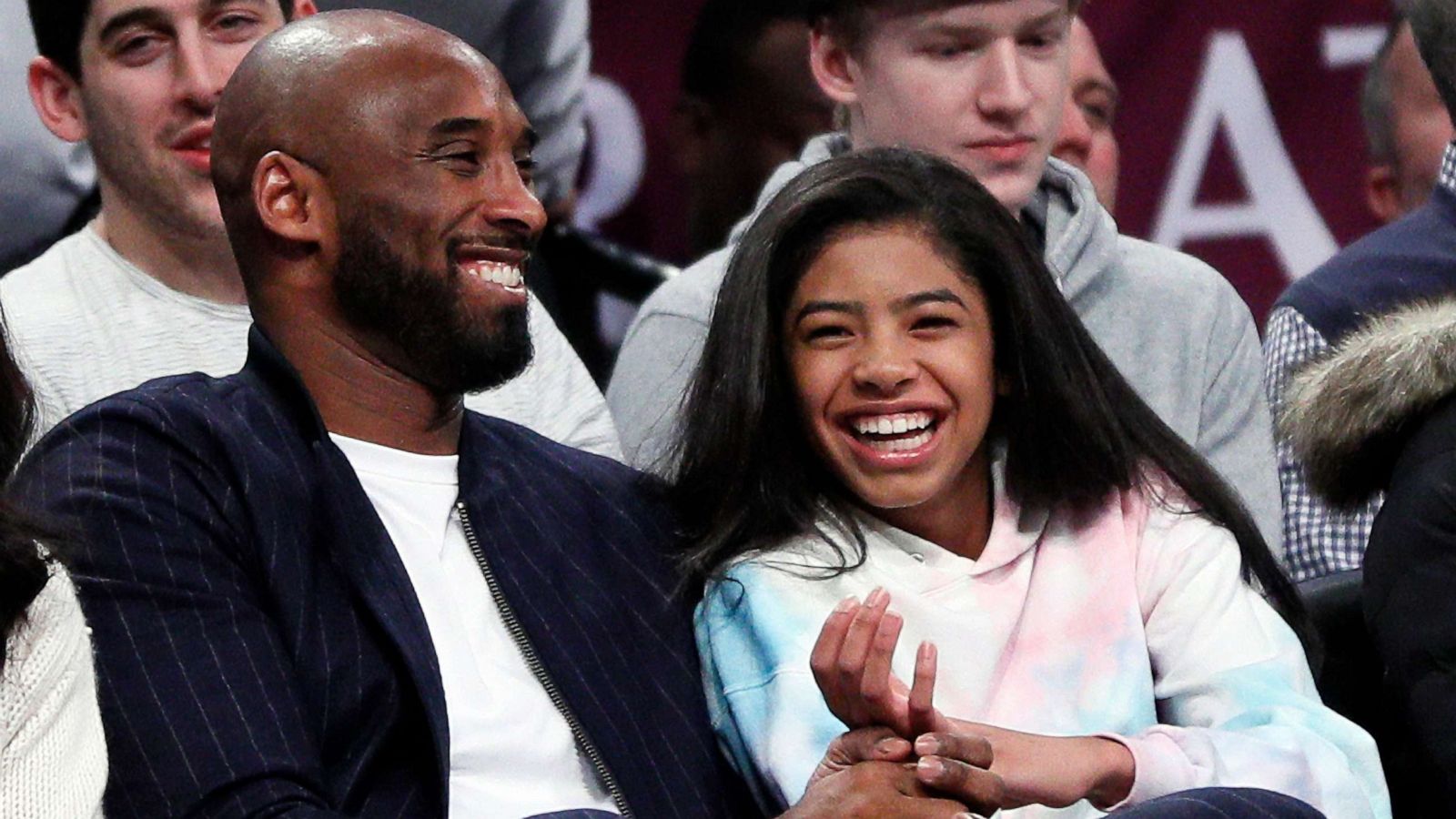 PHOTO: Retired NBA star Kobe Bryant and his daughter Gigi, watch an NBA basketball game, Dec. 21, 2019, at Barclays Center in New York City.