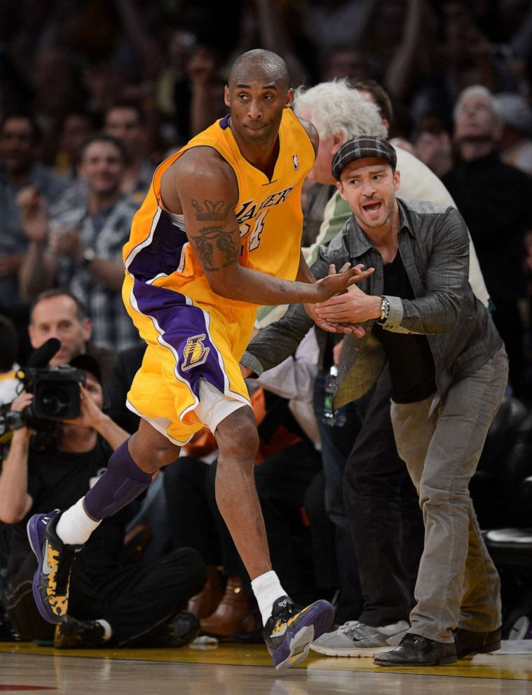 PHOTO: Kobe Bryant of the Los Angeles Lakers reacts with Justin Timberlake after Bryant makes a basket in the fourth quarter against the Denver Nuggets iduring the 2012 NBA Playoffs, May 12, 2012 at Staples Center in Los Angeles. 