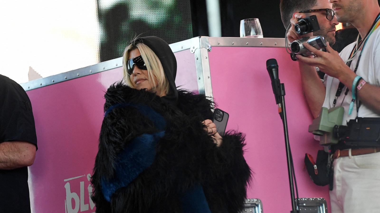 PHOTO: Kourtney Kardashian stands on the side of the stage as her husband Travis Barker performs with his band Blink-182 during the first week-end of Coachella Valley Music and Arts Festival in Indio, Calif. April 14, 2023.