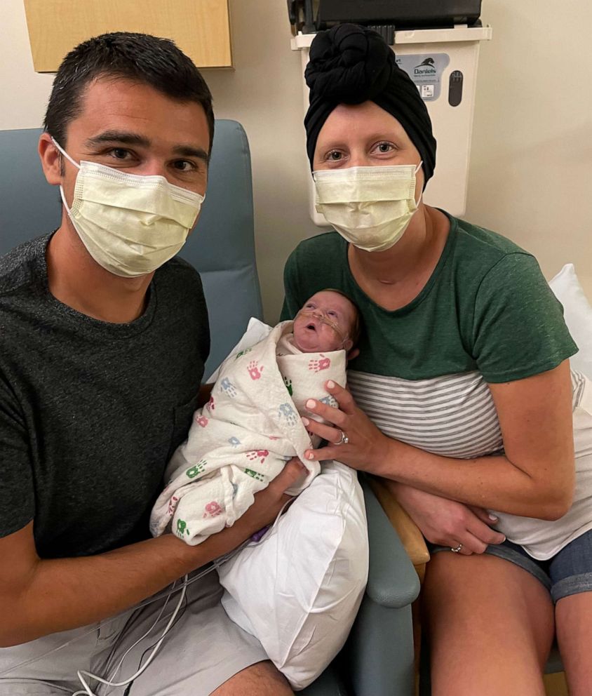 PHOTO: Christine Kump and her husband, Matt, hold their newborn daughter Vivian in the NICU of an Illinois hospital.
