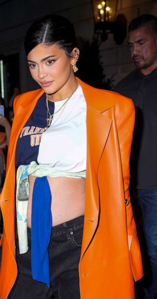 Kylie Jenner shows off VERY taut tummy in orange crop top and