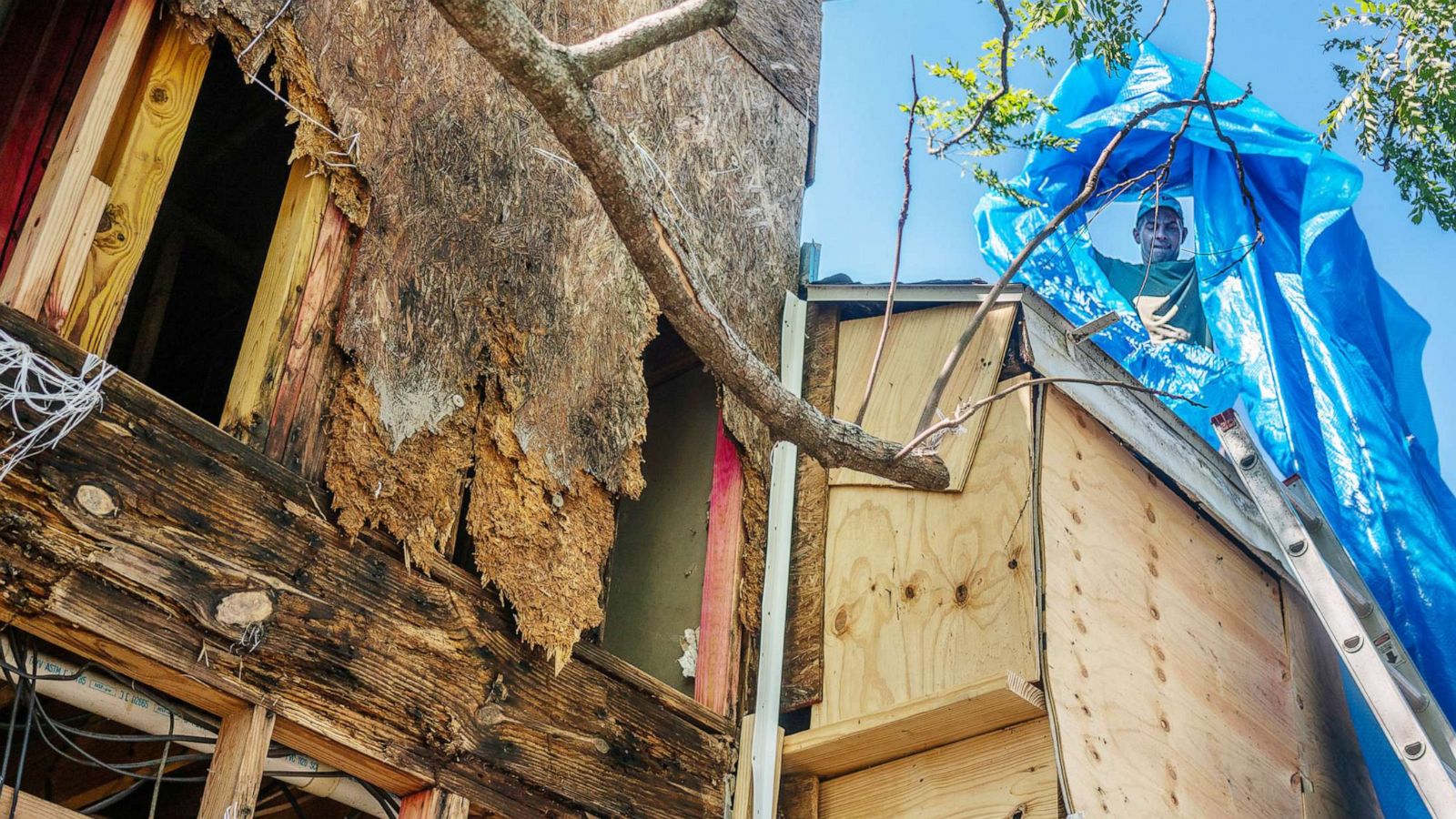 PHOTO: Steve Hebert replaces a tarp on the roof of his townhouse after Hurricane Delta swept through Lake Charles, La., Oct. 10, 2020.