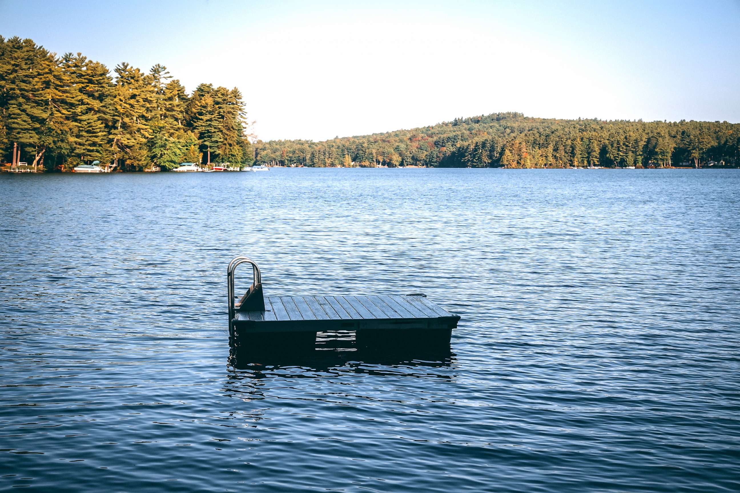 PHOTO: dock with handles on lake with ripples in new england summer