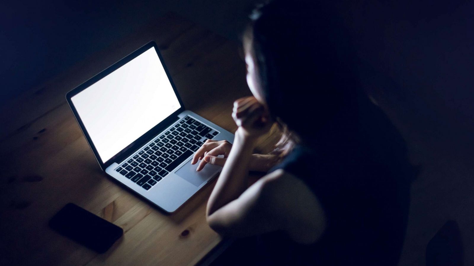 PHOTO: A woman looks at a laptop.