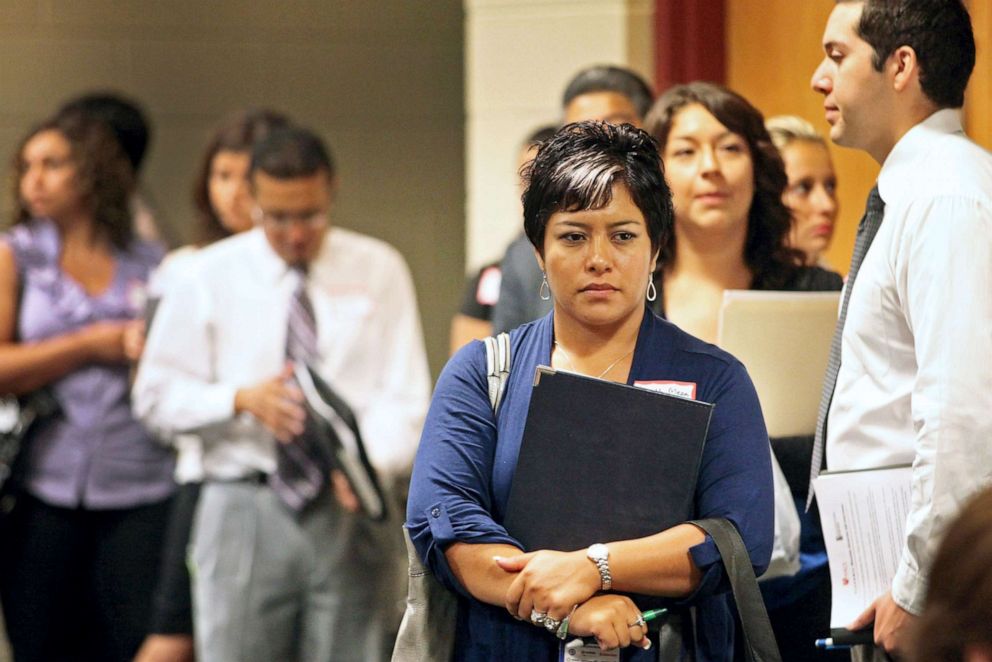 PHOTO: Job seeker Judith Meza Vazquez, second right, waits in line to have her resume reviewed at the Hispanic Alliance for Career Enhancement Conference (HACE) in Chicago, Aug. 4, 2011.