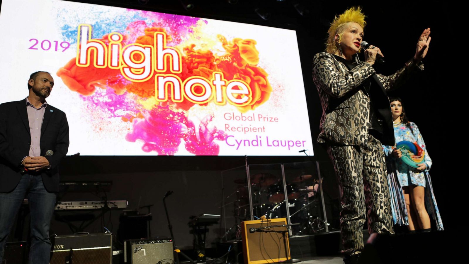 PHOTO: Laurent Sauveur, Chief External Officer of UN Human Rights, and Kesha, present Cyndi Lauper with the High Note Global Prize in Los Angeles, Dec. 10, 2019.