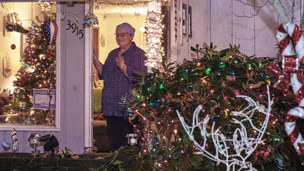 PHOTO: Teacher Laurie Burpee stands outside her Vancouver, Wash., house where her students surprised her with Christmas carols.