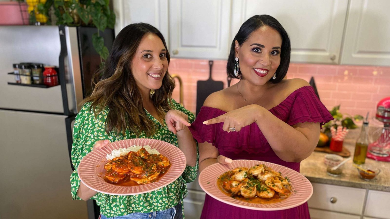 PHOTO: Chef Leah Cohen and Alejandra Ramos holding each other's shrimp dish.