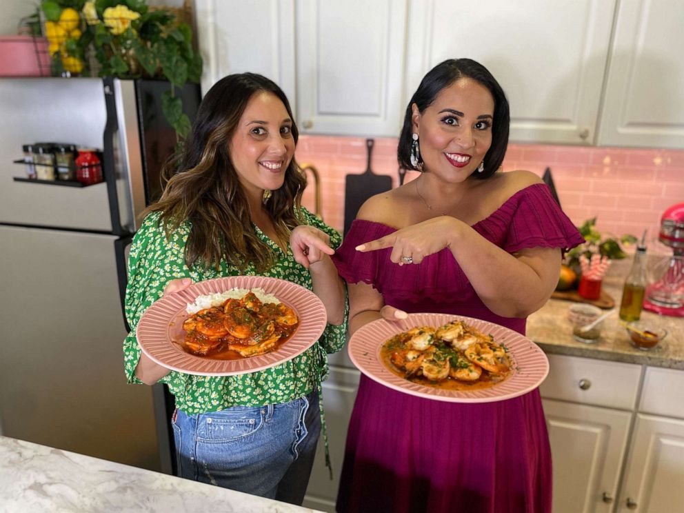 PHOTO: Chef Leah Cohen and Alejandra Ramos holding each other's shrimp dish.