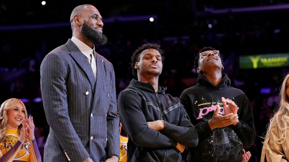 PHOTO: Los Angeles Lakers forward LeBron James, second from left, Bronny James, center, and Bryce James stand during a ceremony honoring LeBron James, Feb. 9, 2023, in Los Angeles.
