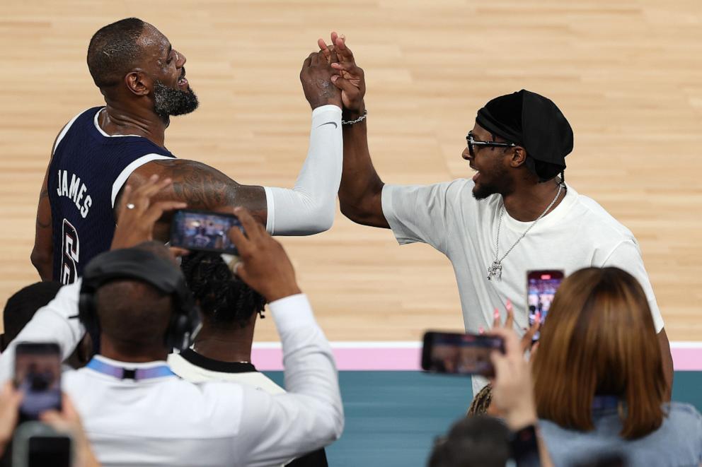 PHOTO: LeBron James of the U.S. high fives his son and Bronny James after defeating France in the men's gold medal basketball game at the 2024 Paris Olympics, Aug. 10, 2024.