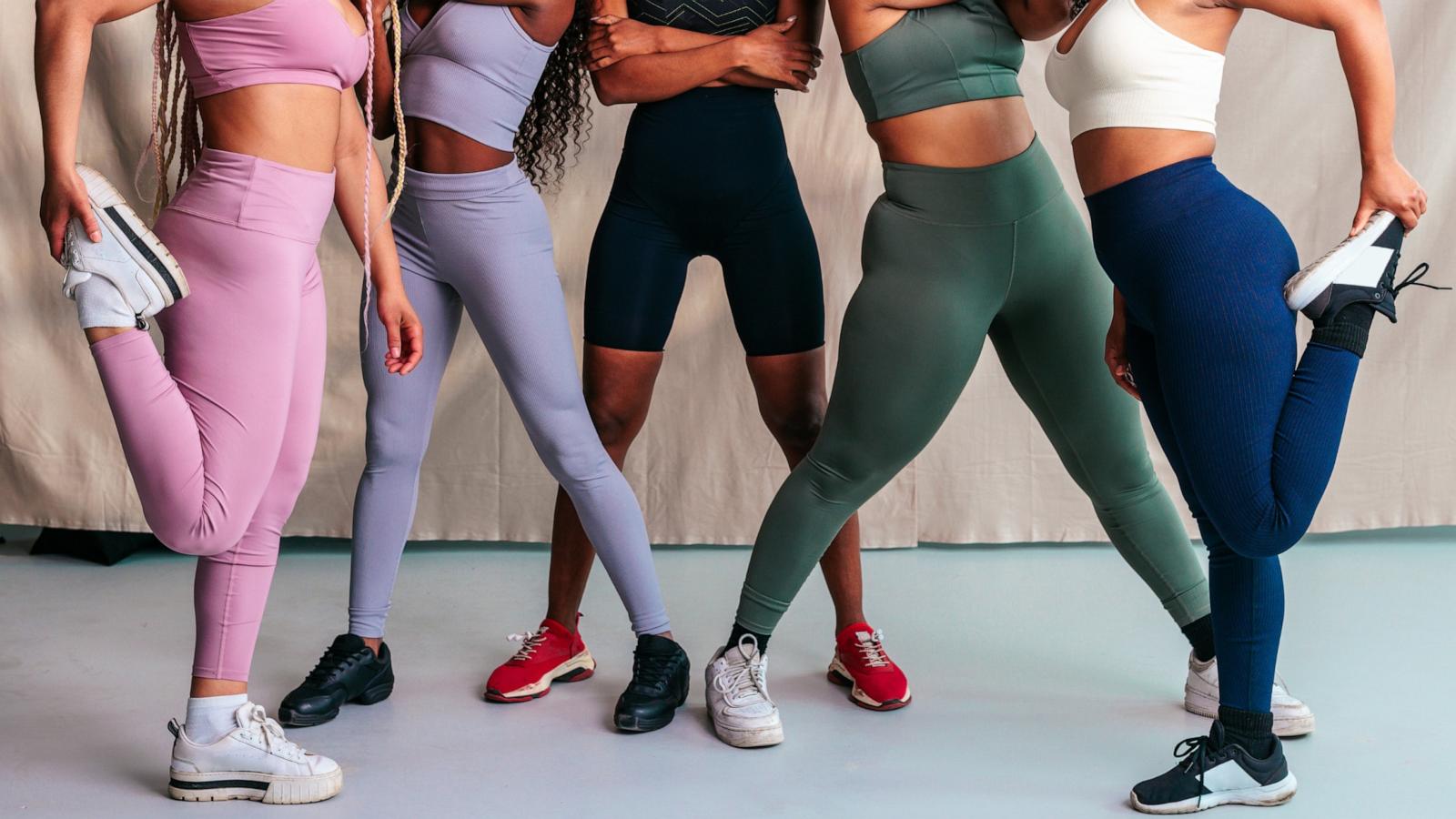 PHOTO: A group of young women stretching together in leggings.