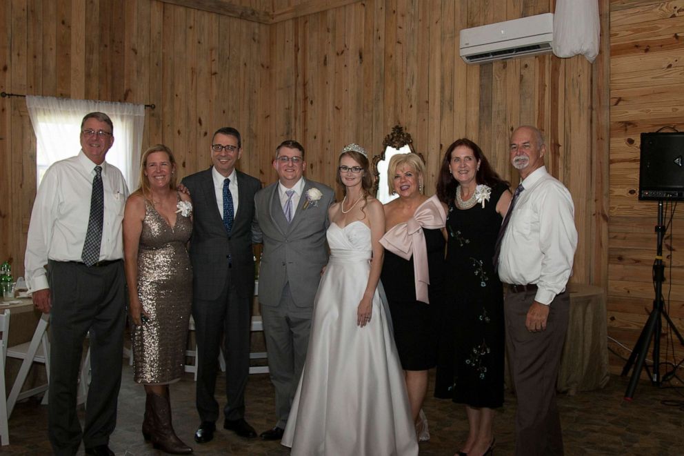 PHOTO: Mark Daugherty and Sam Settle are pictured with loved ones at their wedding in May 2019. 