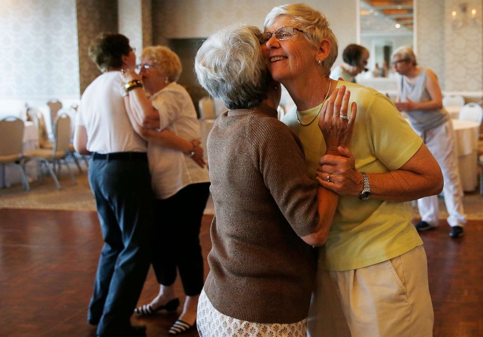 PHOTO: Pam DeMoucell, right, dances with her spouse, Jane Beltramini, both of Pembroke, Mass., during an LGBT senior luncheon in Boston on June 20, 2016.