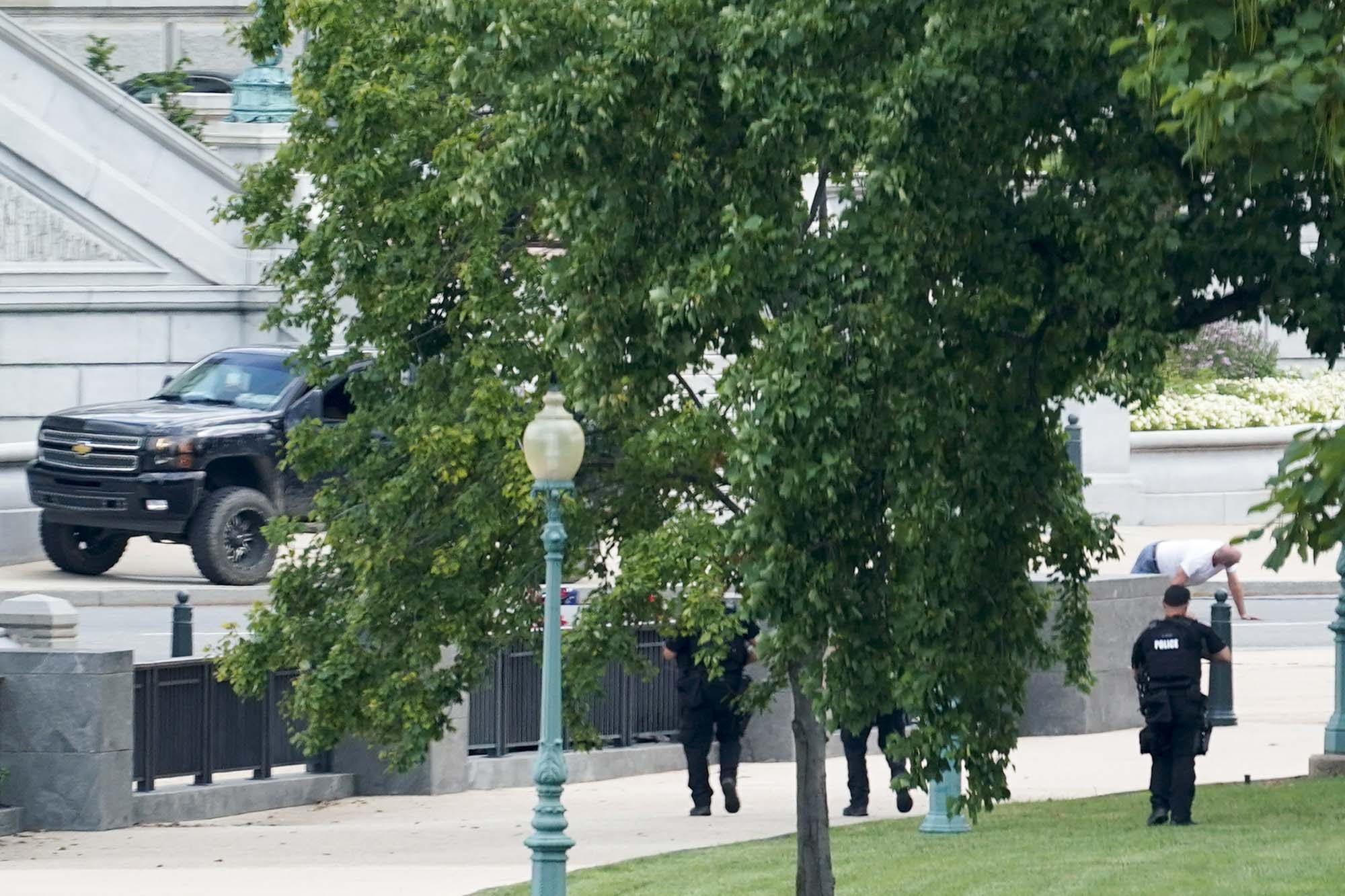 PHOTO: A person is apprehended after being in a pickup truck parked on the sidewalk in front of the Library of Congress' Thomas Jefferson Building, as seen from a window of the U.S. Capitol, Aug. 19, 2021.