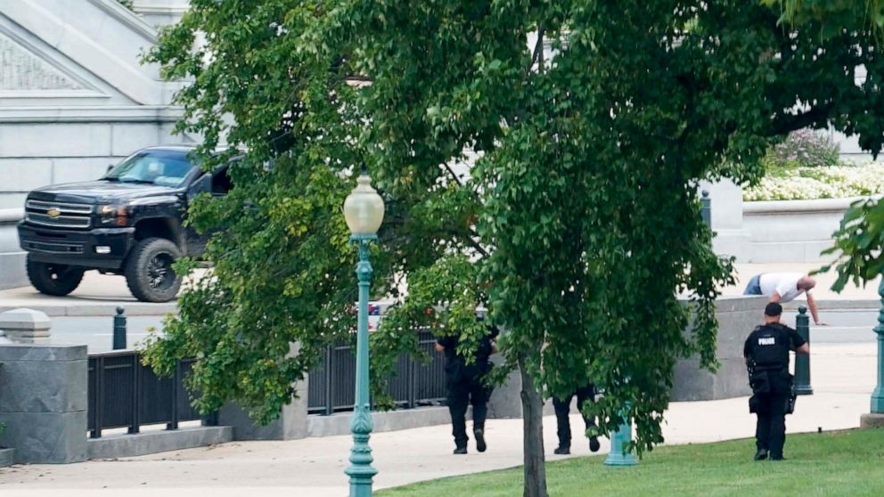 PHOTO: A person is apprehended after being in a pickup truck parked on the sidewalk in front of the Library of Congress' Thomas Jefferson Building, as seen from a window of the U.S. Capitol, Aug. 19, 2021.