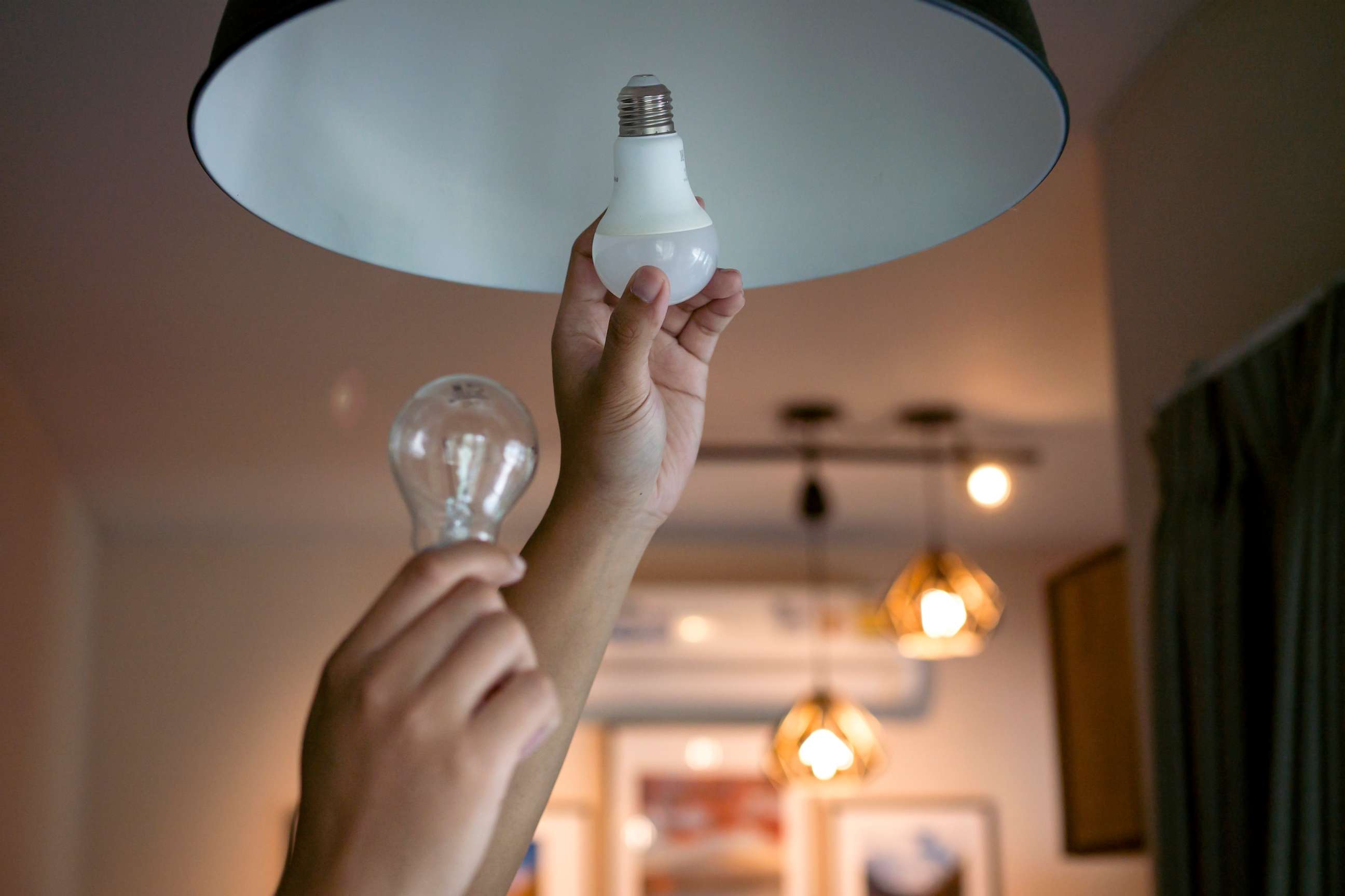 PHOTO: Stock photo of a person changing a lightbulb.