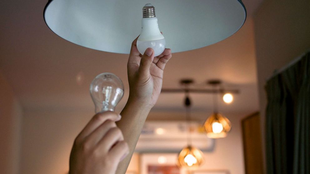 PHOTO: Stock photo of a person changing a lightbulb.