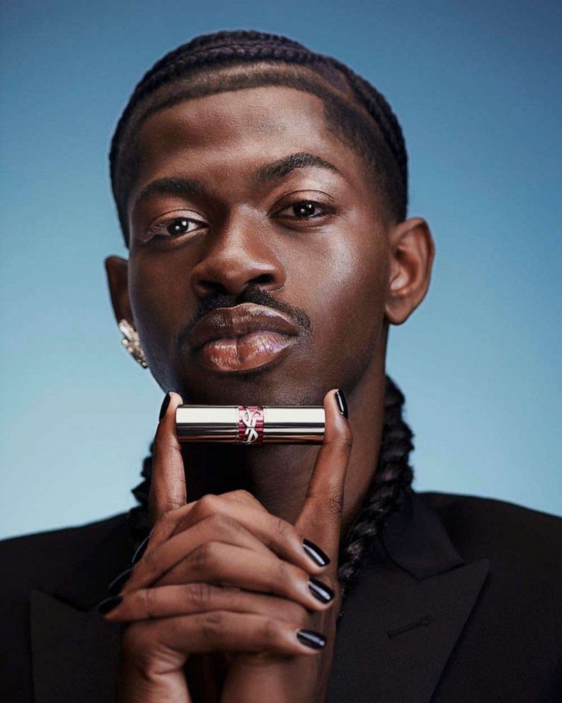PHOTO: Lil Nas X holds the Rouge Volupté Shine Candy Glaze Lip Gloss Stick in this new photo for YSL's Beauty campaign.