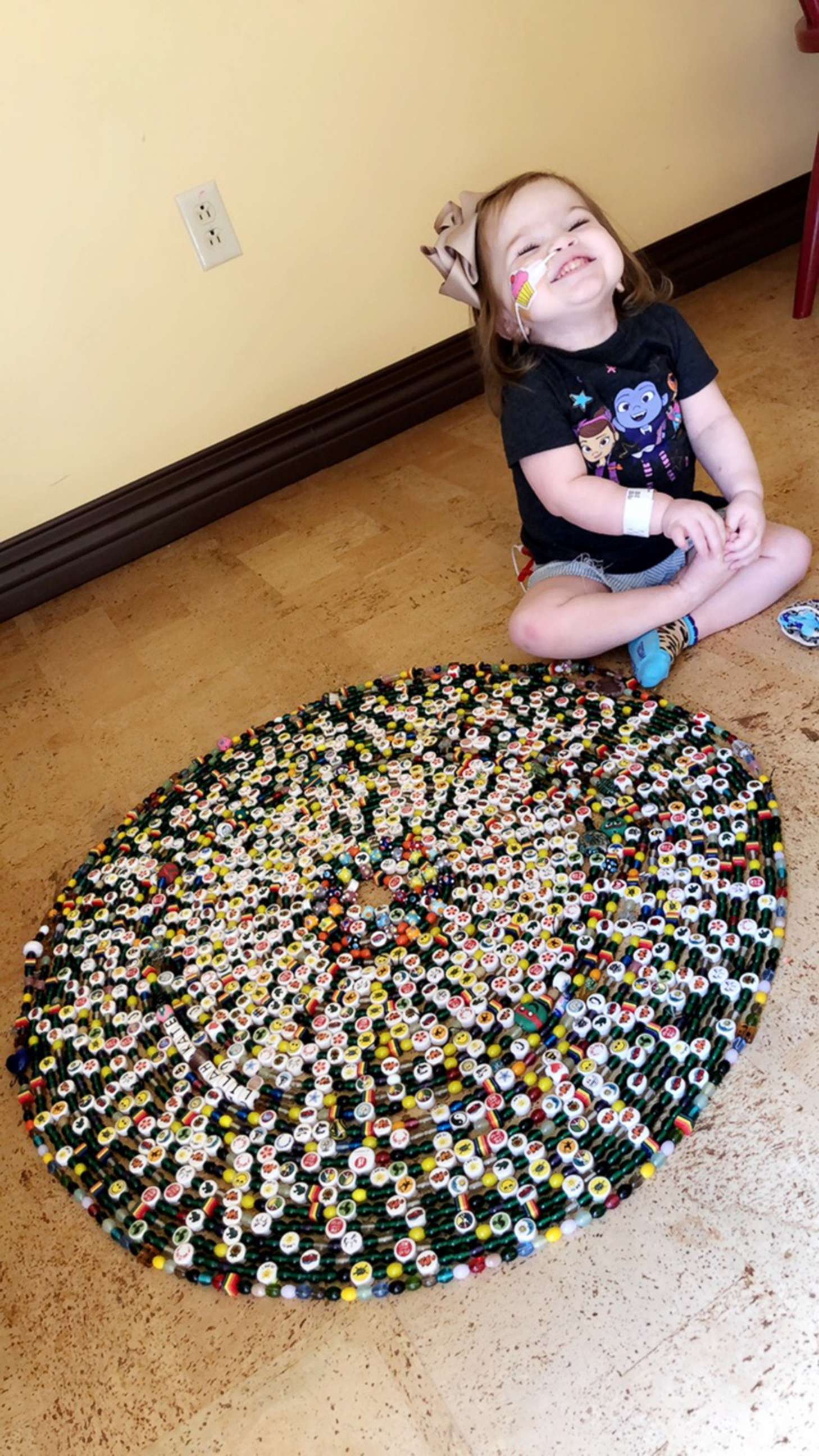 PHOTO: Lilah Joiner sits with her collection of "Beads of Courage" that she was awarded for medical procedures and treatment milestones.