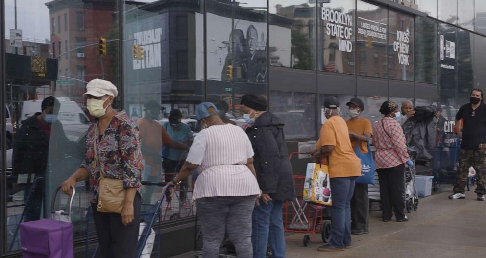 PHOTO: A line of people waiting to receive frozen meals from Tiller & Hatch and Feeding America food banks in front of Barclay's Center in Brooklyn, New York.
