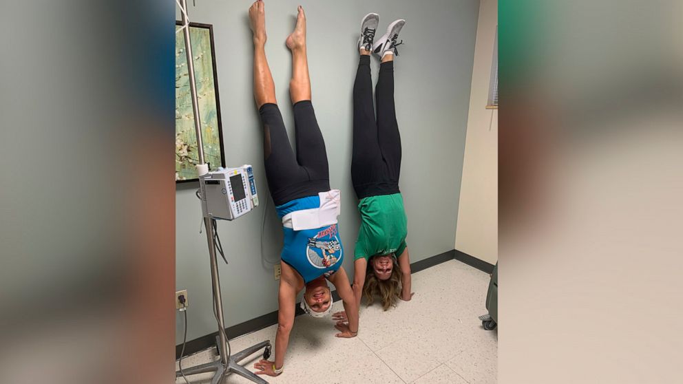PHOTO: Lisa Fosnough, left, does a handstand with a friend during her chemotherapy treatment.