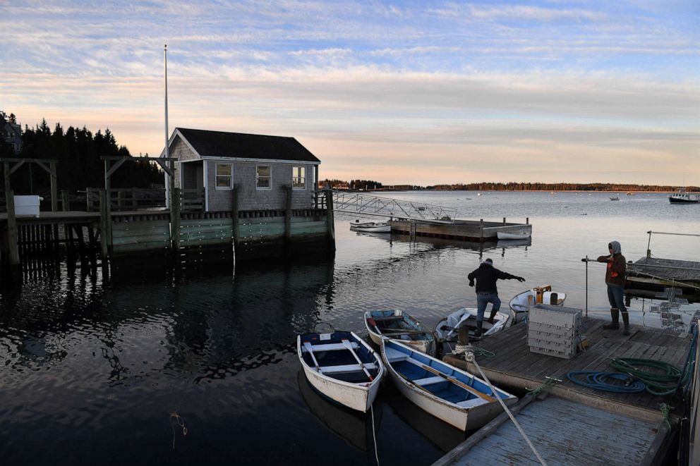 PHOTO: Lobstermen climb into a row boat on Little Cranberry Island, April 29, 2016, in Islesford, Maine.