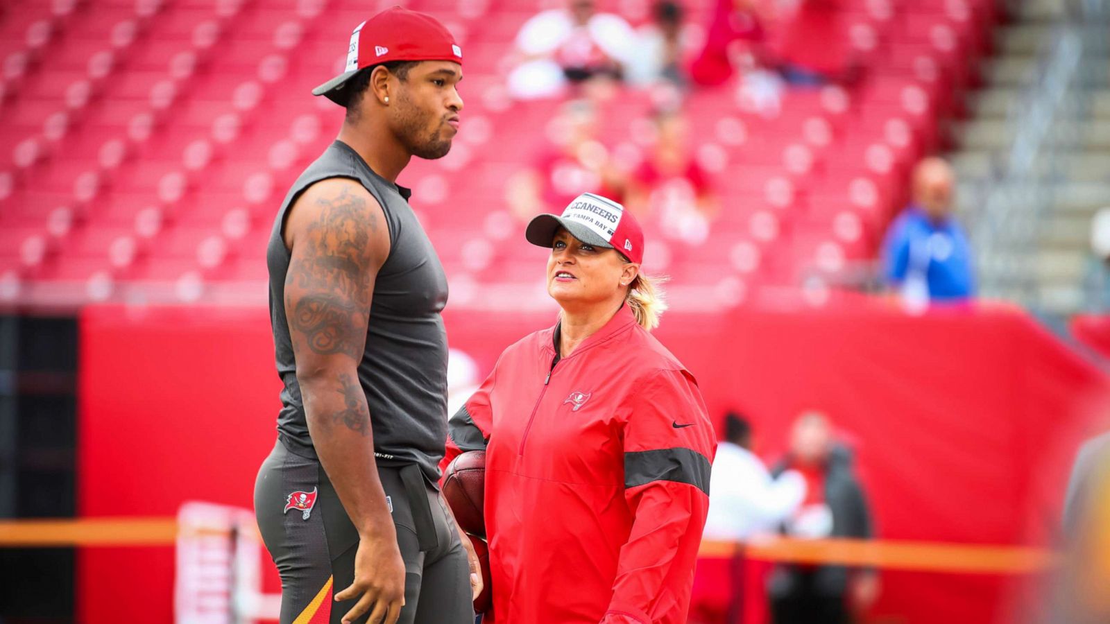 PHOTO: O.J. Howard #80 of the Tampa Bay Buccaneers works with assistant defensive line coach Lori Locust before the game against the Houston Texans, Dec. 21, 2019, at Raymond James Stadium in Tampa, Fla.