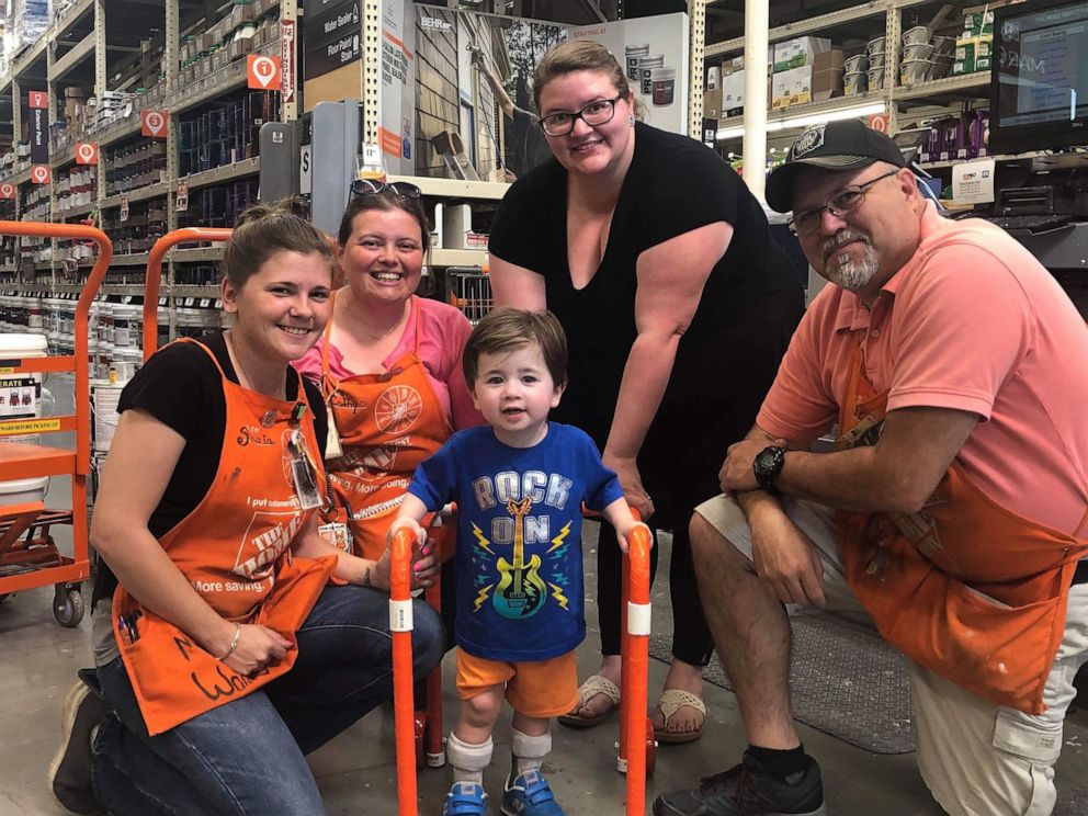 PHOTO: Logan Moore, 2, poses with his mom, Christian Williams Moore and Home Depot employees in Cedartown, Ga., May 22, 2019.