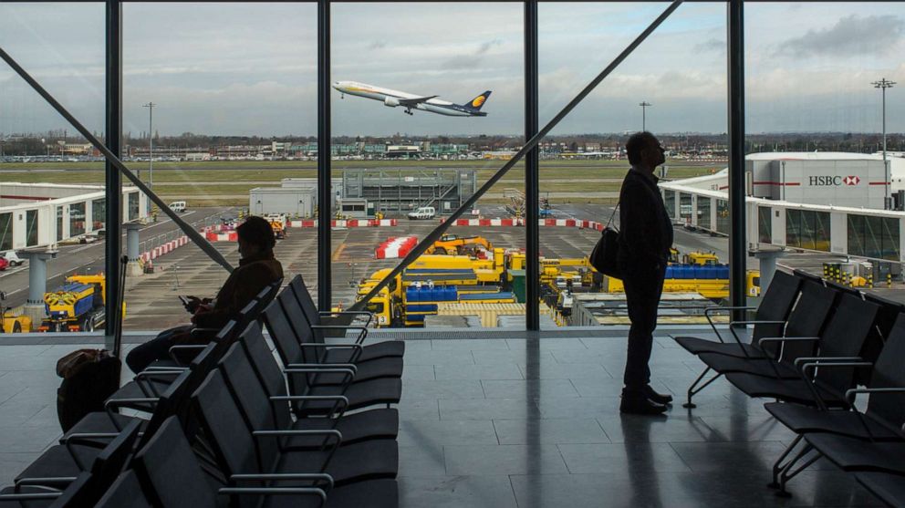 PHOTO: Airline passengers wait for their flights February 19, 2014 as a Lufthansa flight takes off at Heathrow International Airport in London, England.