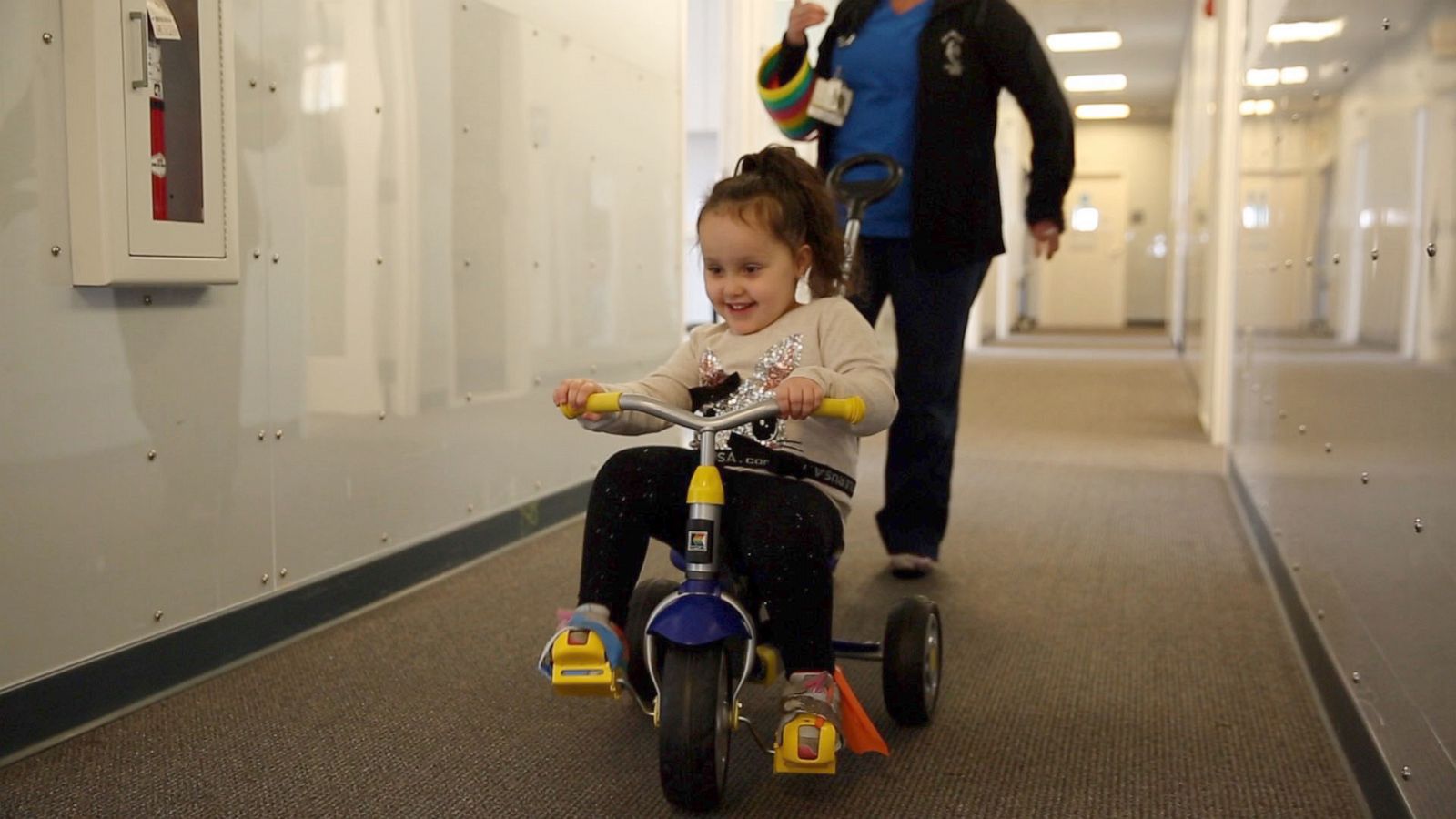 PHOTO: London Fazekas, a five-year-old with spina bifida, rides her bike in physical therapy at Hasbro Children's Hospital in Providence, Rhode Island.