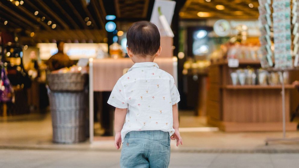 PHOTO: Back view a lonely toddler boy standing and crying alone on A toddler is pictured standing alone and without his parents in shopping mall, in this stock image.