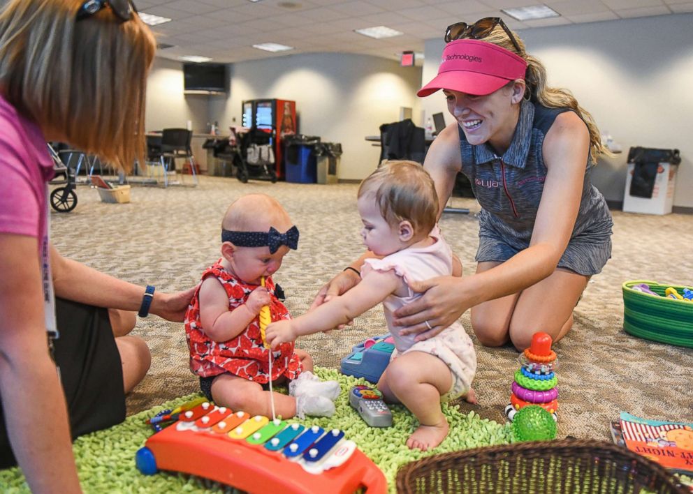 PHOTO: Golfer Sydnee Michaels, right, and her baby greet LPGA employee Kelly Schultz, left, and her baby at an event in Indianapolis, Aug. 15, 2018.