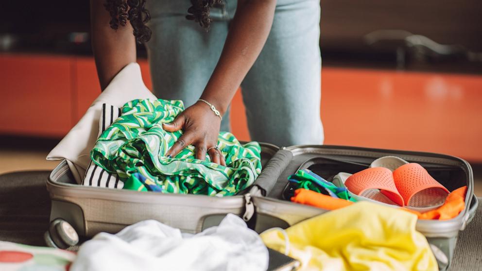 PHOTO: Stock photo of a person packing a suitcase.