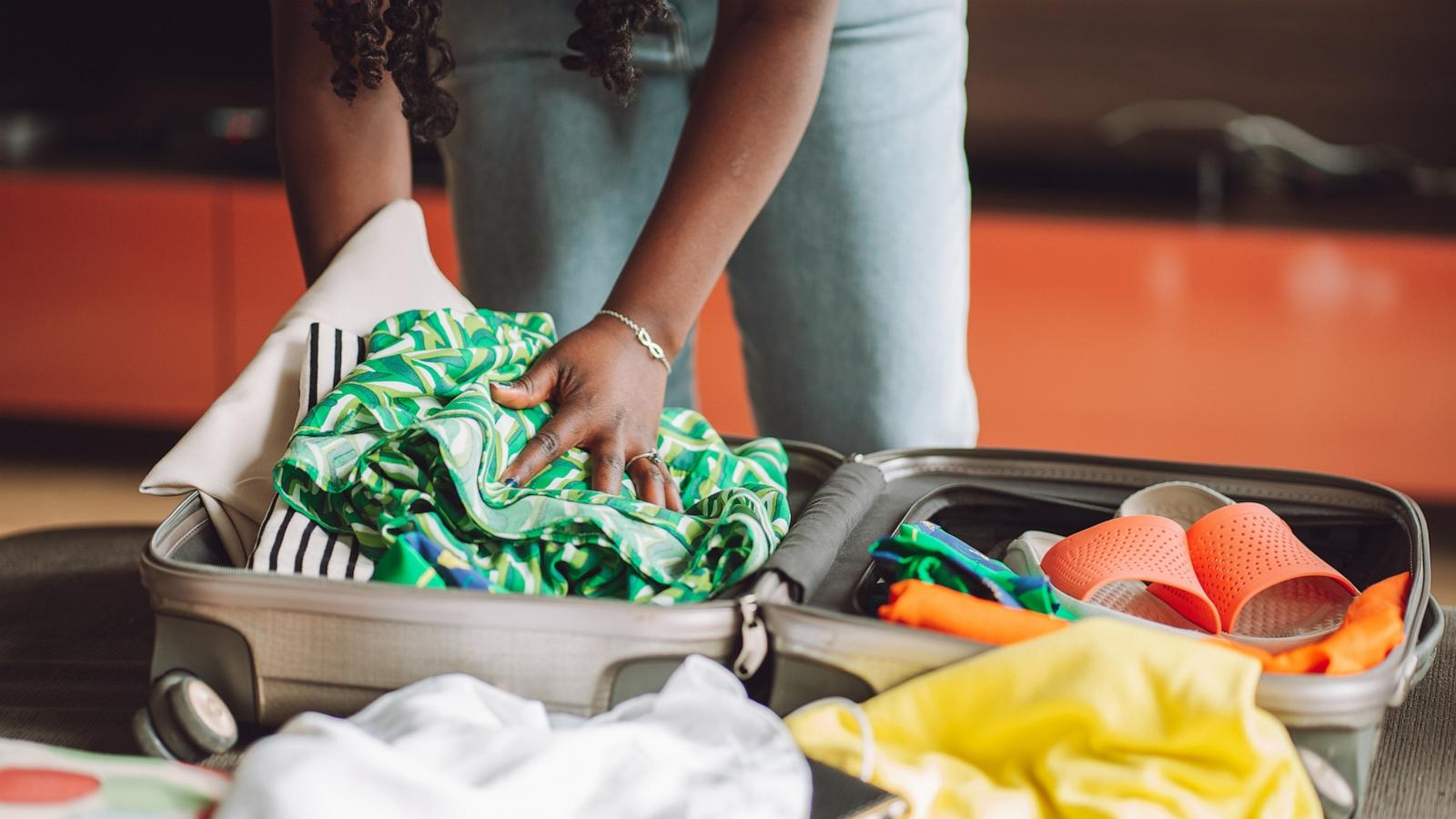 PHOTO: Stock photo of a person packing a suitcase.