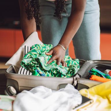 PHOTO: Stock photo of a person packing a suitcase.