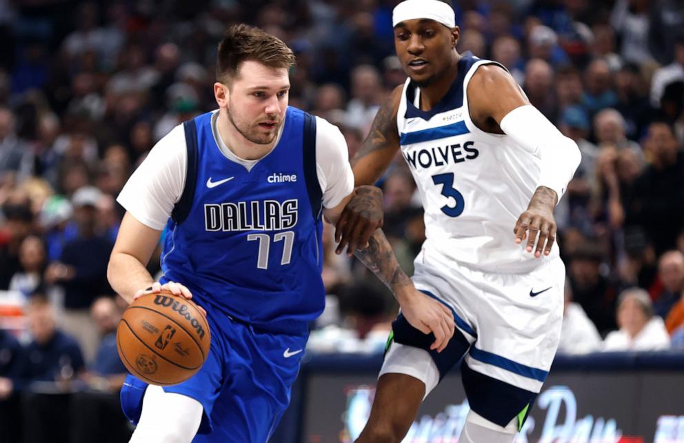 PHOTO: Luka Doncic #77 of the Dallas Mavericks handles the ball as Jaden McDaniels #3 of the Minnesota Timberwolves defends in the first half at American Airlines Center in Dallas, Tex., Dec. 25, 2024.