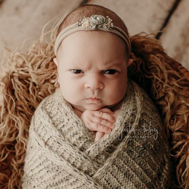 This baby is not feeling it during her newborn photo session