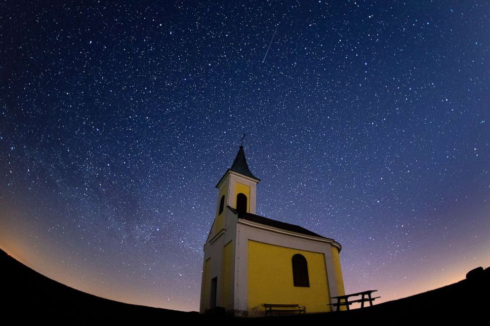 PHOTO: rids meteor shower streaks across the sky over Michaelskapelle on April 21, 2020 in Niederhollabrunn, Austria.