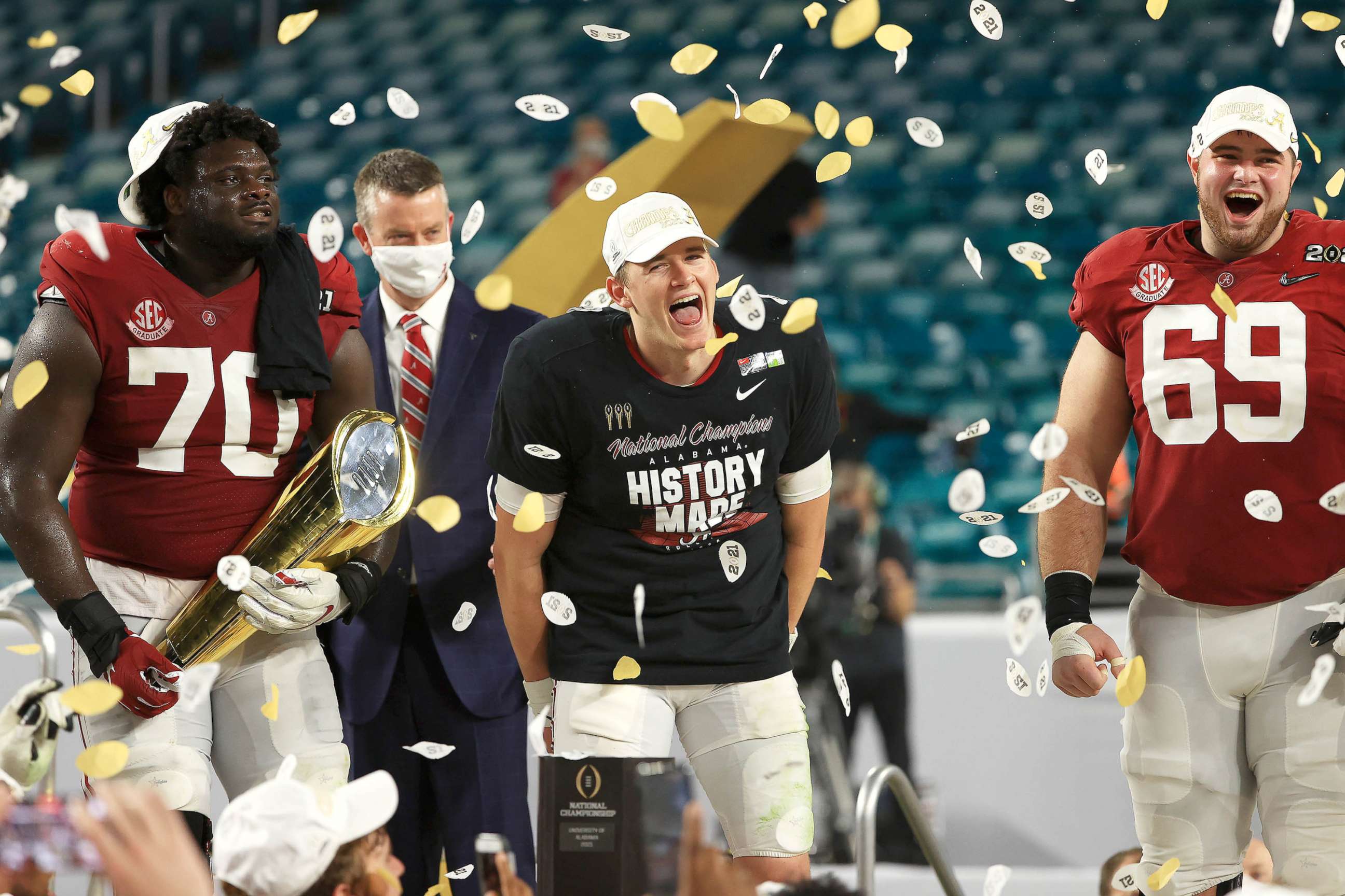 PHOTO:  Mac Jones #10 of the Alabama Crimson Tide celebrates alongside Alex Leatherwood #70 following their win over the Ohio State Buckeyes in the College Football Playoff National Championship game on Jan. 11, 2021 in Miami Gardens, Fla.