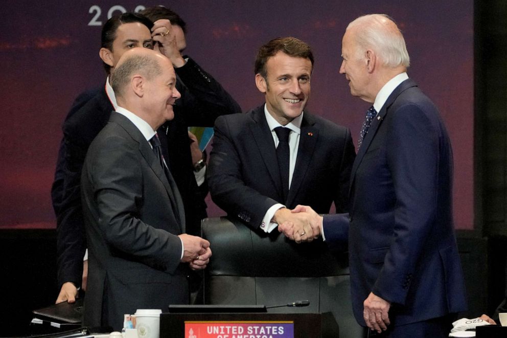 PHOTO: President Joe Biden shakes hands with French President Emmanuel Macron as German Chancellor Olaf Scholz looks on during the G20 leaders' summit in Nusa Dua, Bali, Indonesia, Nov. 15, 2022.
