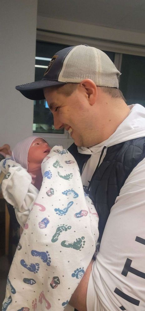 PHOTO: Robbie Stevenson smiles as he gazes at his newborn daughter Theodora MaddieKay Stevenson.