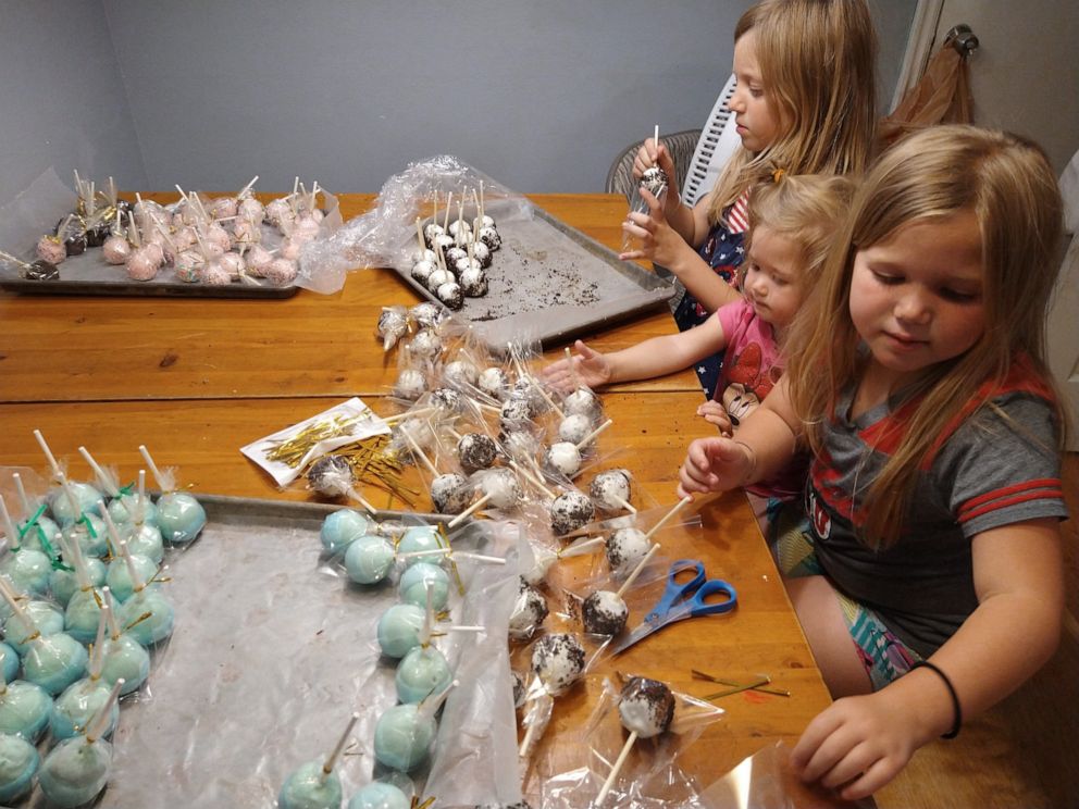 PHOTO: Myleigh, Paetyn, and Makayla Madsen preparing cake pops to sell at the lemonade stand in front of their home in West Jordan, Utah.