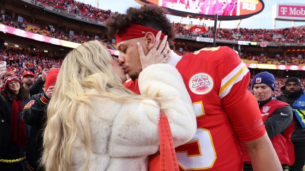 PHOTO: Patrick Mahomes #15 of the Kansas City Chiefs kisse wife, Brittany Mahomes, prior to the AFC Championship Game against the Buffalo Bills at GEHA Field at Arrowhead Stadium on January 26, 2025 in Kansas City, Missouri.