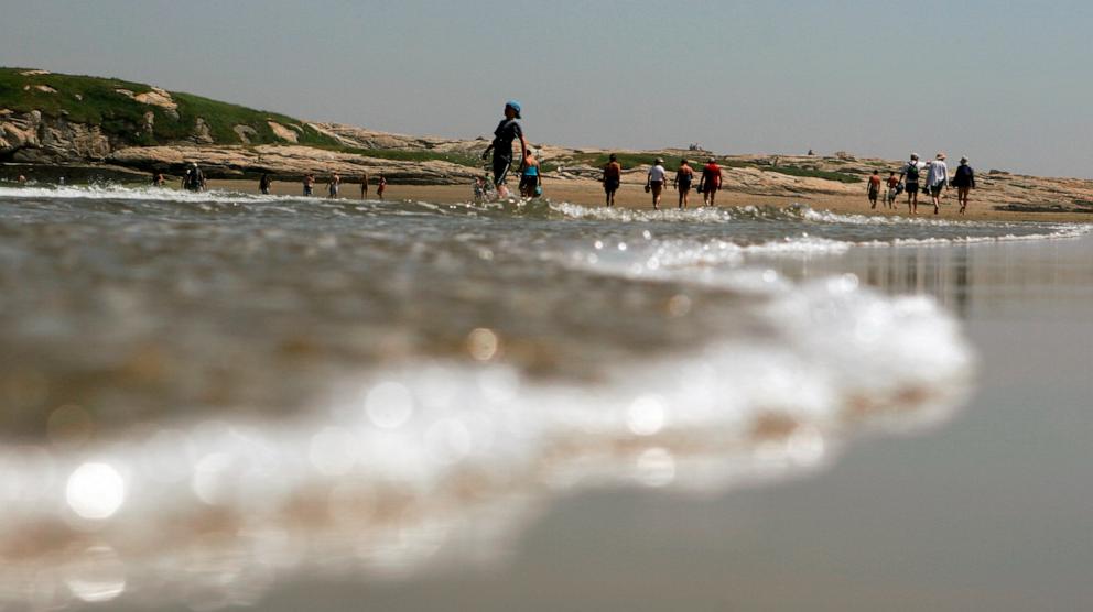 PHOTO: In this June 26, 2007 file photo beachgoers enjoy the walk at low tide out to Fox Island off of Popham Beach State Park in Phippsburg, Maine.