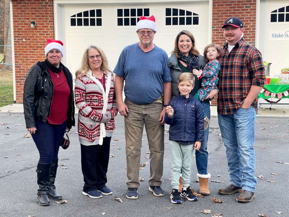 PHOTO: Wyatt and his family smiling with the Fullers, who helped his wish come true by creating a dazzling Christmas light display.