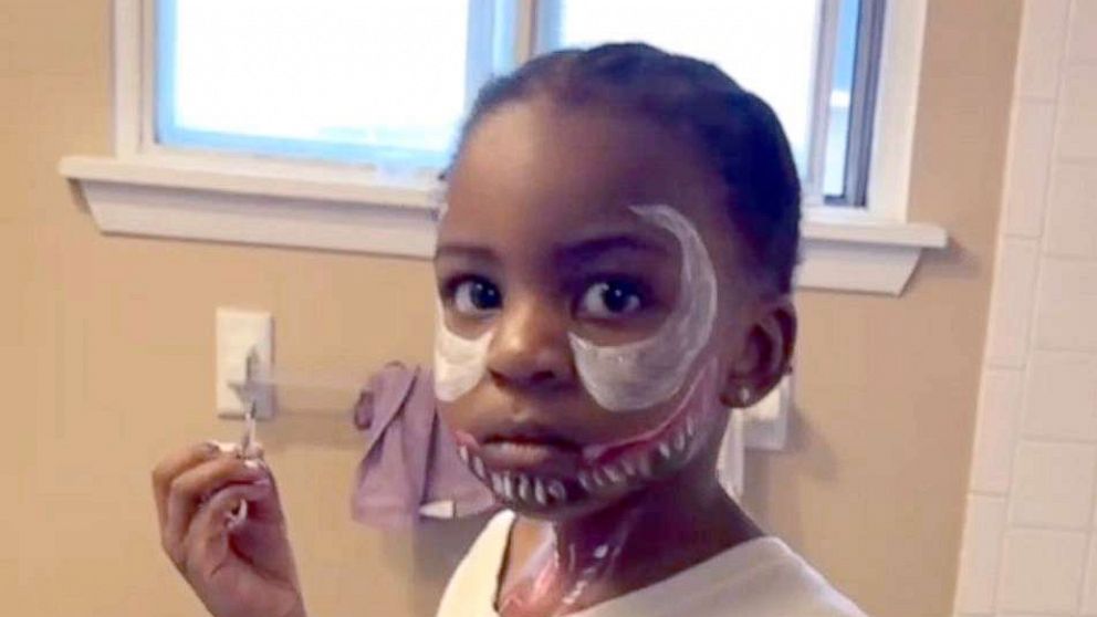 PHOTO: Dakota Patton, 3, putting on face paint of the character Venom.